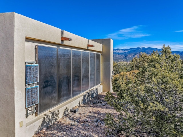 view of side of home with a mountain view