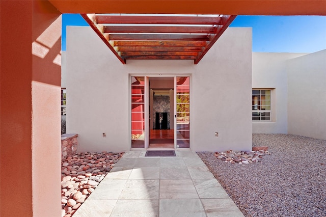 property entrance featuring a pergola