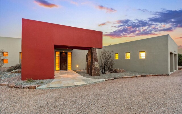 back house at dusk featuring a mountain view