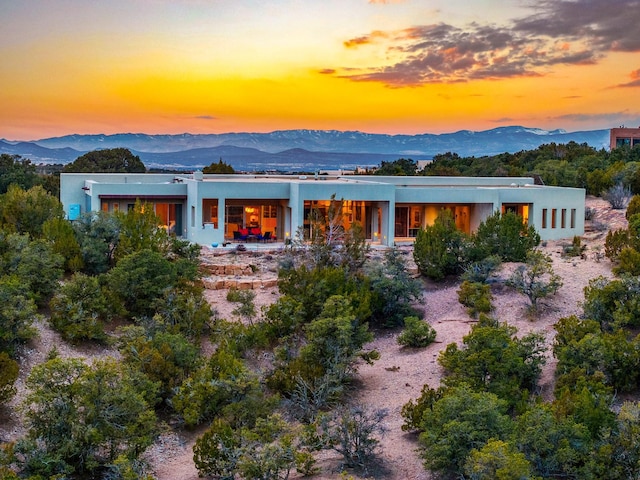 back house at dusk with a mountain view