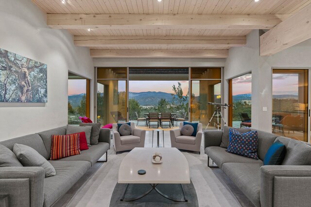 sunroom / solarium featuring a mountain view, wooden ceiling, and beamed ceiling