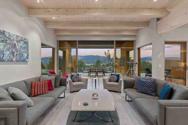 sunroom with beamed ceiling, a mountain view, and wooden ceiling