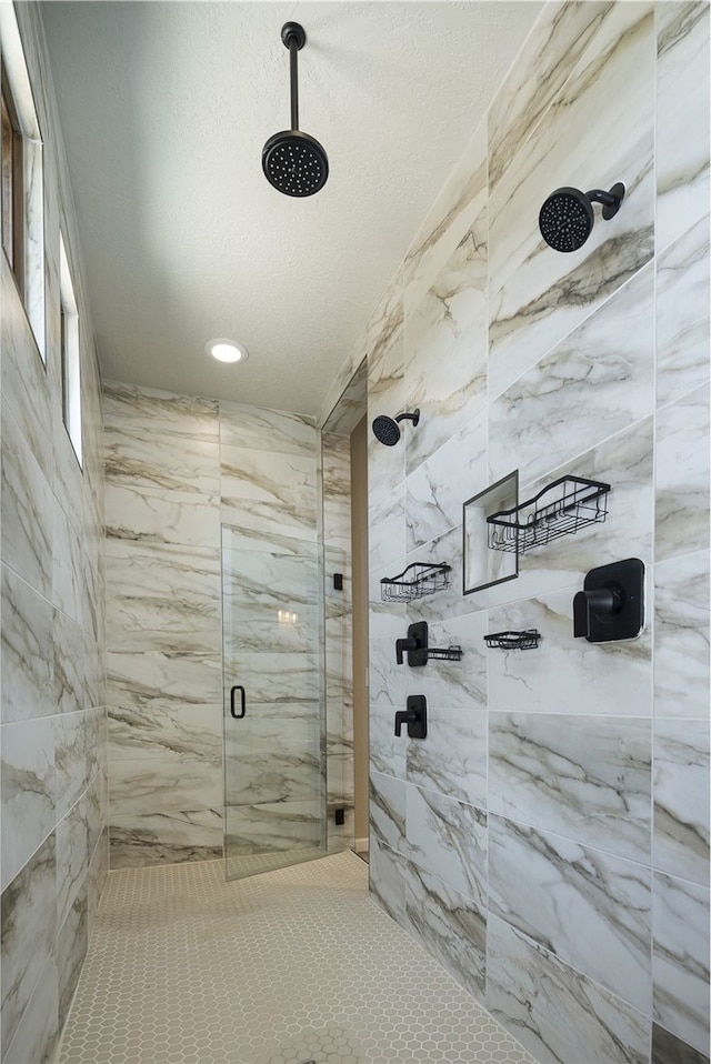 bathroom featuring a textured ceiling and tiled shower