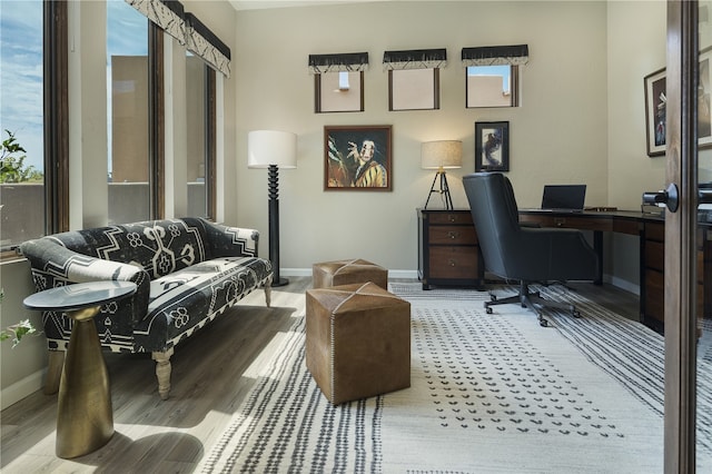 home office with light hardwood / wood-style floors