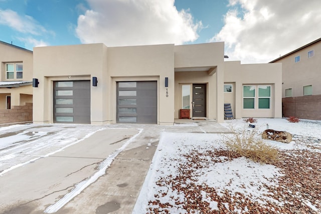 pueblo-style home featuring a garage