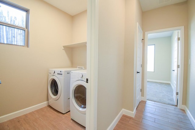 clothes washing area featuring independent washer and dryer