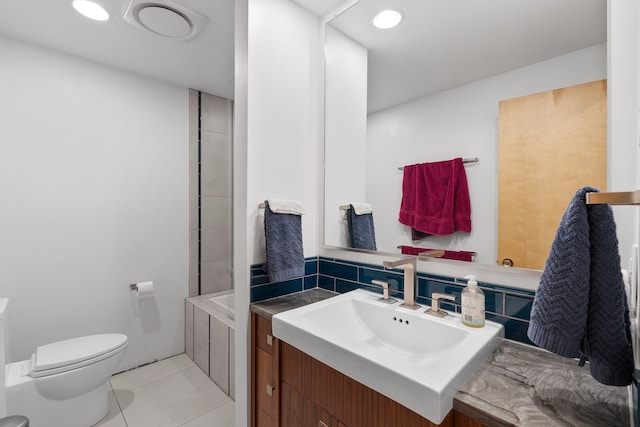 bathroom with tile patterned flooring, vanity, and toilet