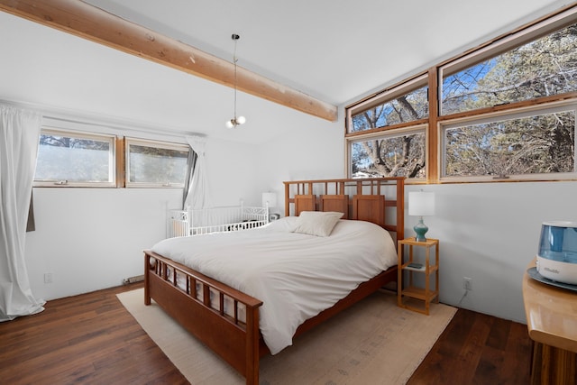 bedroom with dark hardwood / wood-style flooring and lofted ceiling with beams