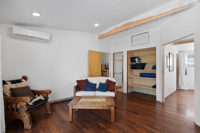 living area featuring a wall mounted air conditioner, dark hardwood / wood-style flooring, and built in features