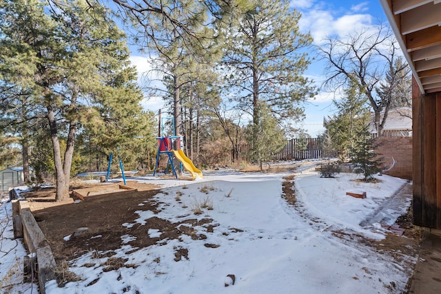 snowy yard with a playground