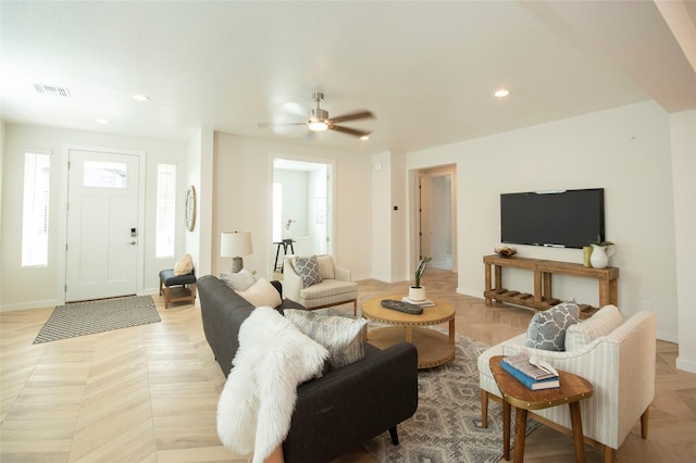 living room featuring light parquet flooring and ceiling fan