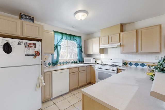 kitchen with light tile patterned floors, decorative backsplash, white appliances, light brown cabinetry, and sink