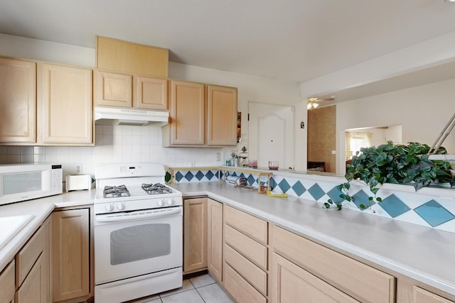 kitchen featuring white appliances, tasteful backsplash, light brown cabinetry, light tile patterned flooring, and ceiling fan