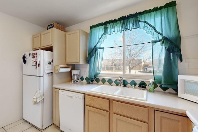 kitchen featuring sink, white appliances, and light brown cabinets