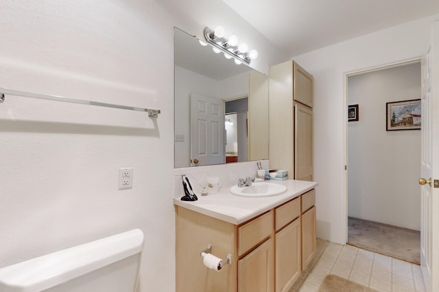 bathroom featuring toilet and vanity