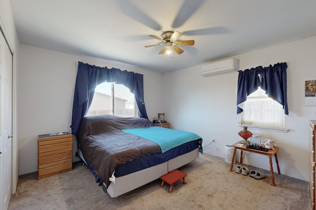 carpeted bedroom with ceiling fan, a wall mounted AC, and a closet