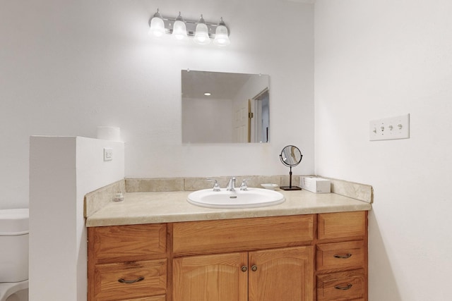 bathroom featuring toilet and vanity