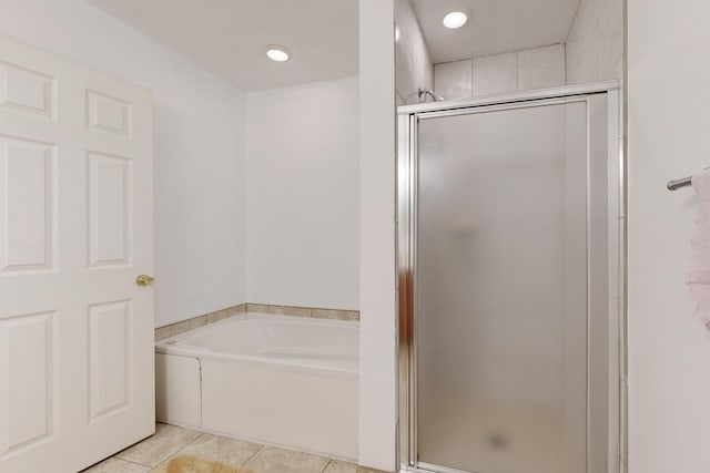 bathroom featuring plus walk in shower and tile patterned flooring