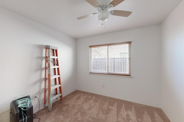 unfurnished room with ceiling fan and carpet