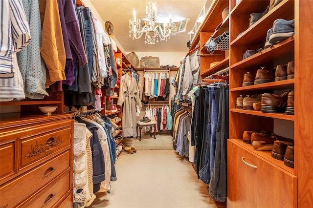 spacious closet featuring light colored carpet and a chandelier