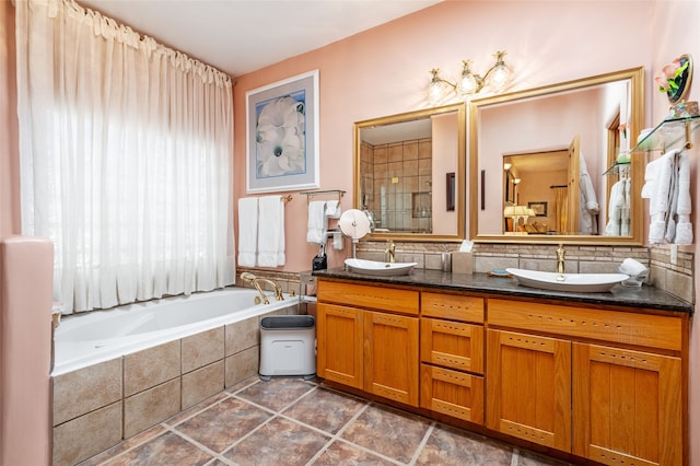 bathroom featuring vanity and tiled tub