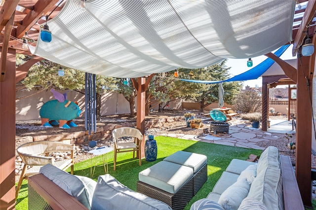 view of patio with an outdoor living space with a fire pit