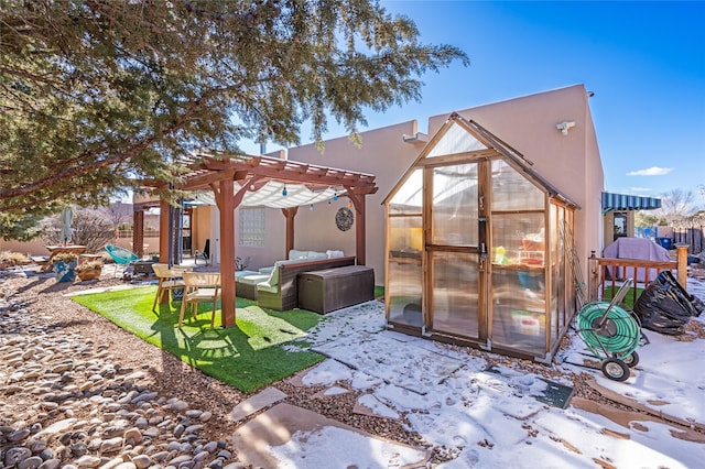 view of outdoor structure with an outdoor living space and a pergola