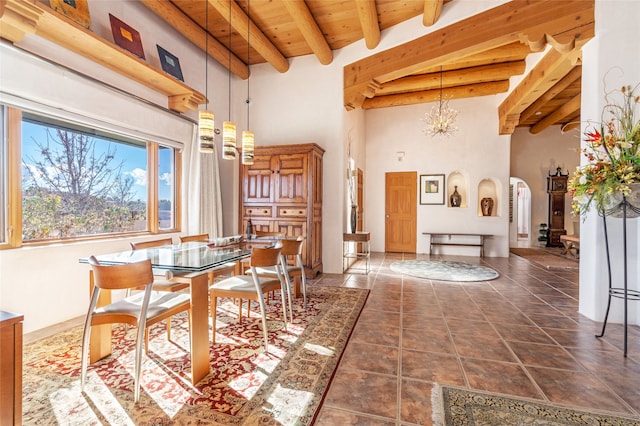 tiled dining room with a high ceiling, wooden ceiling, beam ceiling, and a notable chandelier