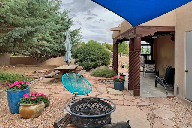 view of patio featuring an outdoor fire pit