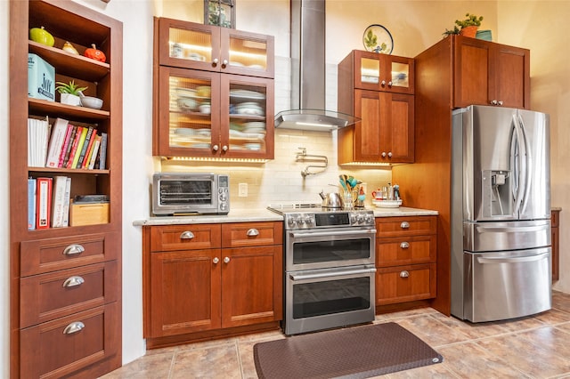 kitchen featuring backsplash, wall chimney range hood, and stainless steel appliances