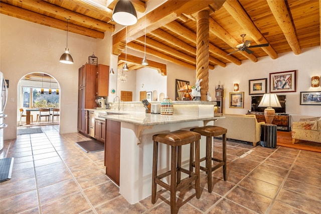 kitchen with wooden ceiling, beam ceiling, and decorative light fixtures