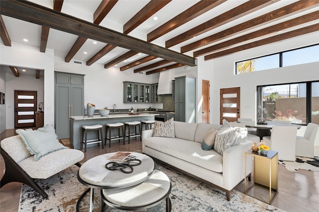 living room featuring sink and beamed ceiling