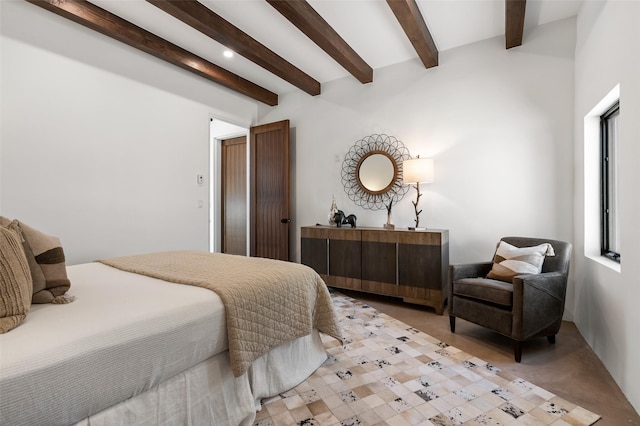 bedroom featuring beamed ceiling and multiple windows