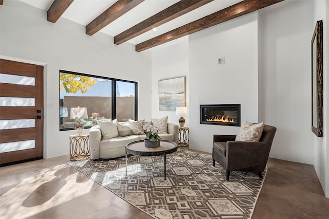 living room featuring concrete flooring and beamed ceiling