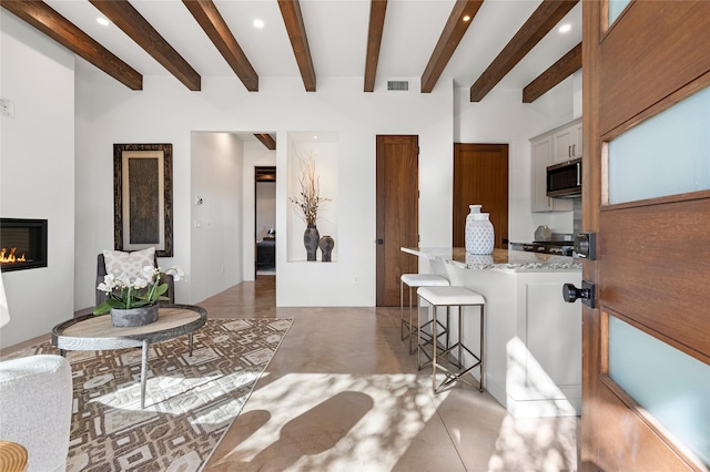 living room with beam ceiling