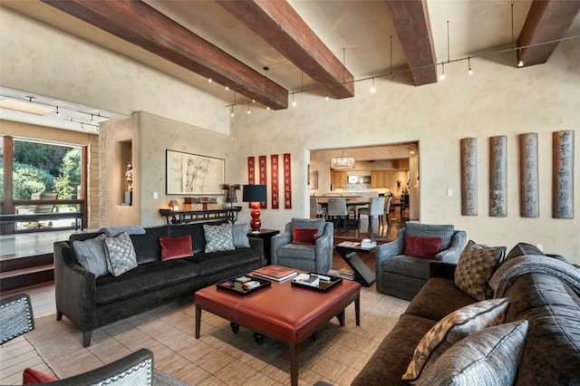 living room featuring beamed ceiling and track lighting