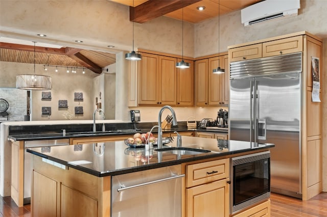 kitchen featuring a wall mounted AC, beamed ceiling, built in appliances, and pendant lighting