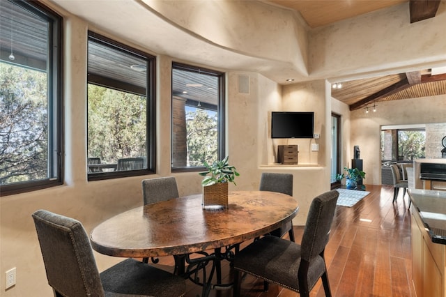 dining space with vaulted ceiling with beams, wood-type flooring, and wooden ceiling