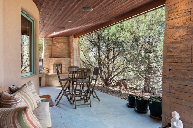 view of patio with an outdoor stone fireplace