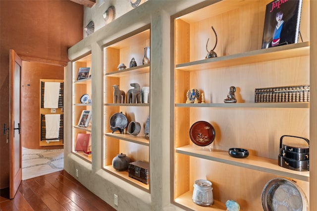 room details featuring wood-type flooring and built in shelves