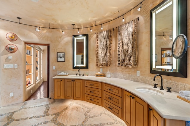 bathroom featuring backsplash and vanity