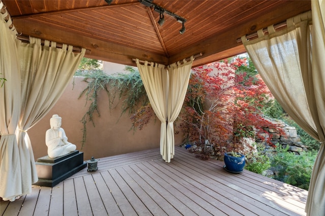 wooden terrace featuring a gazebo