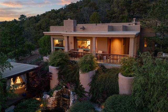 view of back house at dusk