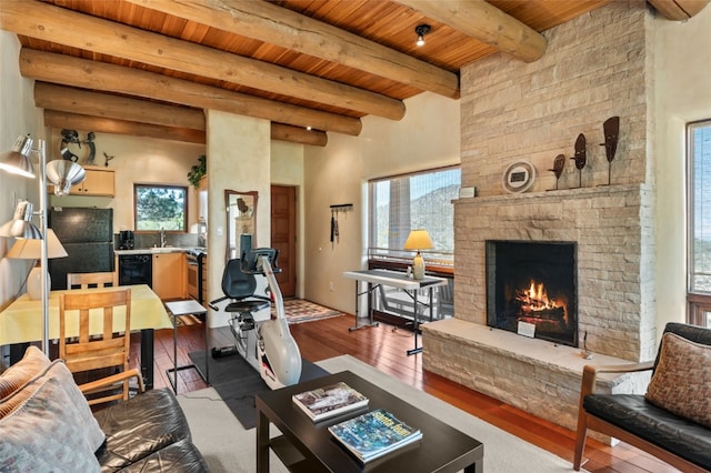 living room featuring a fireplace, wood ceiling, beam ceiling, and a healthy amount of sunlight