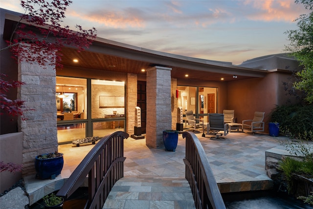 view of patio terrace at dusk