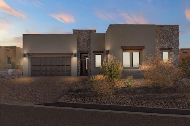 pueblo-style house featuring a garage