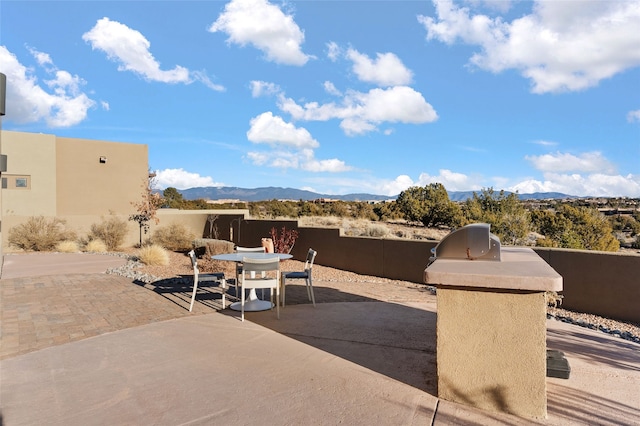 view of patio / terrace with a mountain view and an outdoor kitchen