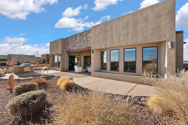 back of property with a patio area