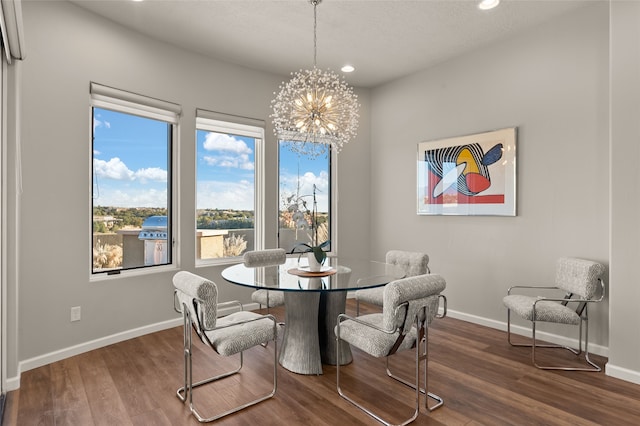 dining room with hardwood / wood-style floors and a notable chandelier