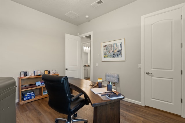 office area featuring a textured ceiling and dark hardwood / wood-style flooring